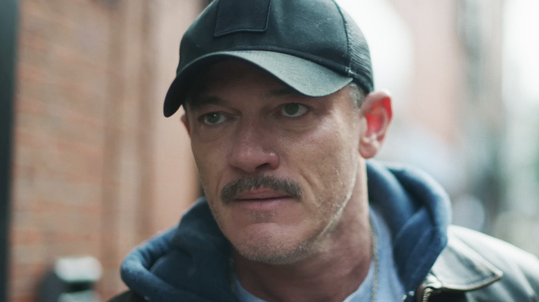 Luke Evans' Adam is seen in closeup as he stands on a street in 5lbs of Pressure