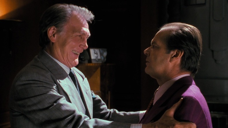 Jack Palance's Carl Grissom grips the arms of Jack Nicholson's Jack Napier in Batman