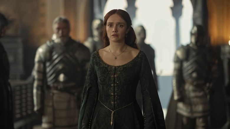 Alicent looking horrified in her green dress walking down the hallway on House of the Dragon