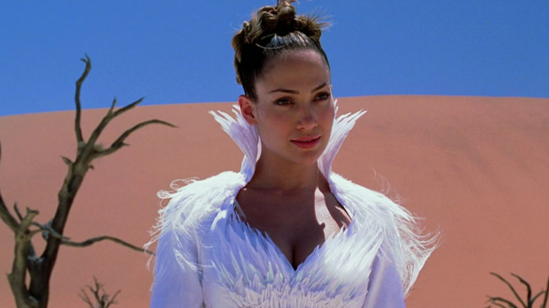 Jennifer Lopez as Catherine Deane standing in a desert in a white dress in The Cell