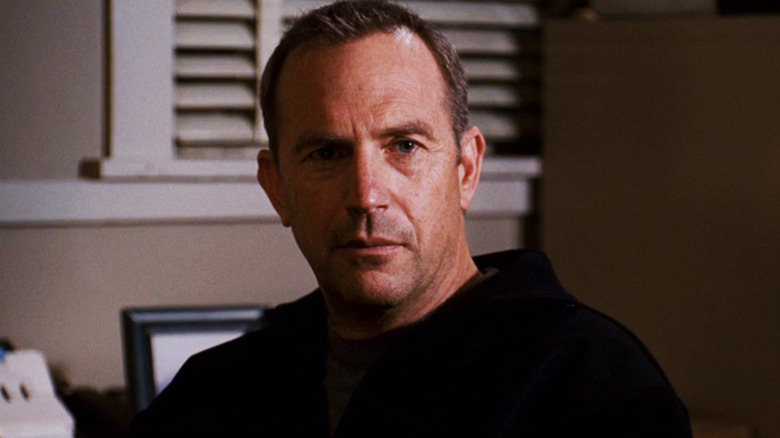 Kevin Costner's Ben Randall looks across at someone offscreen in The Guardian
