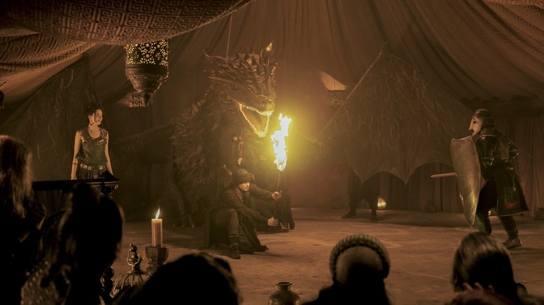 Tanselle performs a play about Serwyn of the Mirror Shield with a massive puppet dragon in A Knight of the Seven Kingdoms