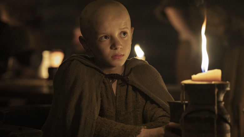Dexter Sol Ansell as Egg sitting next to a candle in A Knight of the Seven Kingdoms