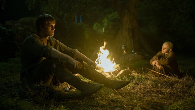 Peter Claffey's Dunk and Dexter Sol Ansell's Egg sitting by a fire on A Knight of the Seven Kingdoms