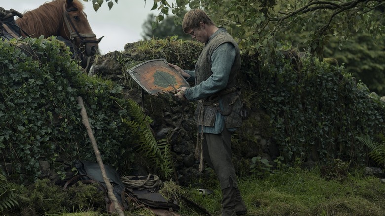 Ser Duncan the Tall looking at his broken shield in A Knight of the Seven Kingdoms