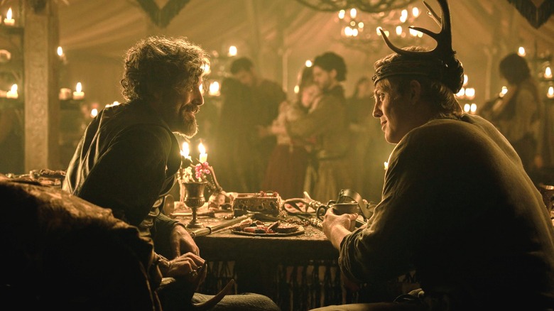 Daniel Ings as Lyonel Baratheon sitting next to Peter Claffey as Dunk wearing a crown of antlers in A Knight of the Seven Kingdoms