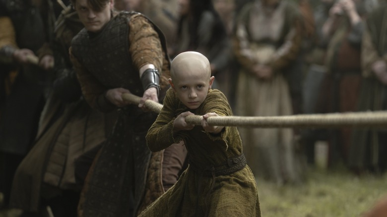 Dexter Sol Ansell as Egg pulling on a rope in a game of tug-of-war in A Knight of the Seven Kingdoms