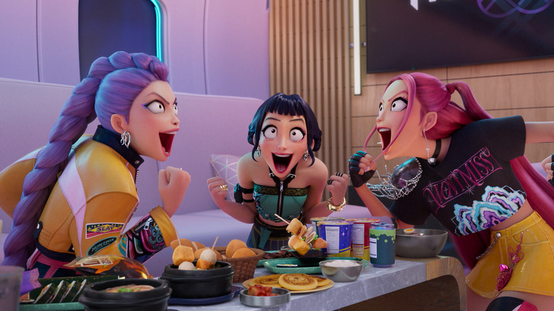 Rumi, Zoey, and Mira yelling around a table of food in KPop Demon Hunters