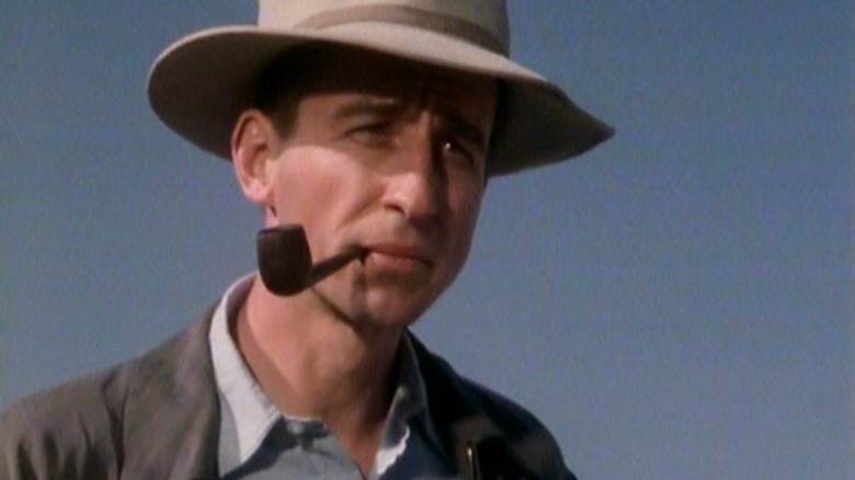 Robert Oppenheimer smoking a pipe in the 1980 miniseries Oppenheimer.