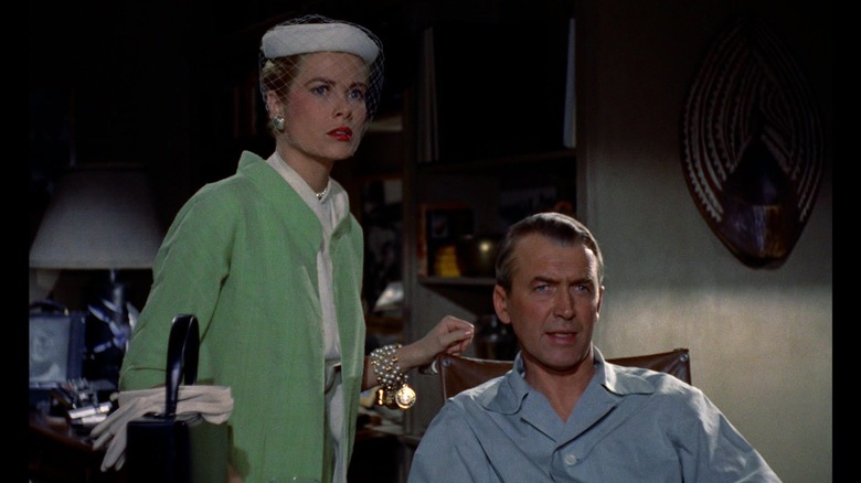 James Stewart's L.B. Jeff Jefferies sits looking off into the distance as Grace Kelly's Lisa stands next to him in Rear Window