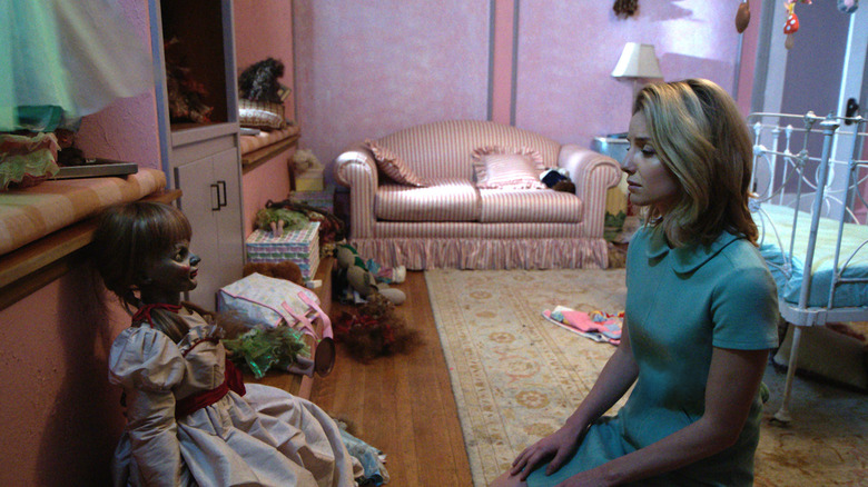 Annabelle Wallis as Mia looking at the Annabelle doll in the nursery in Annabelle