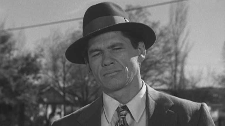 Charles Bronson as George Kelly wearing a hat in Machine-Gun Kelly