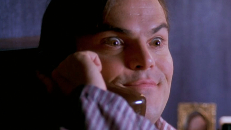 Jack Black's Nick Vanderpark looks excited on a phone call in Envy