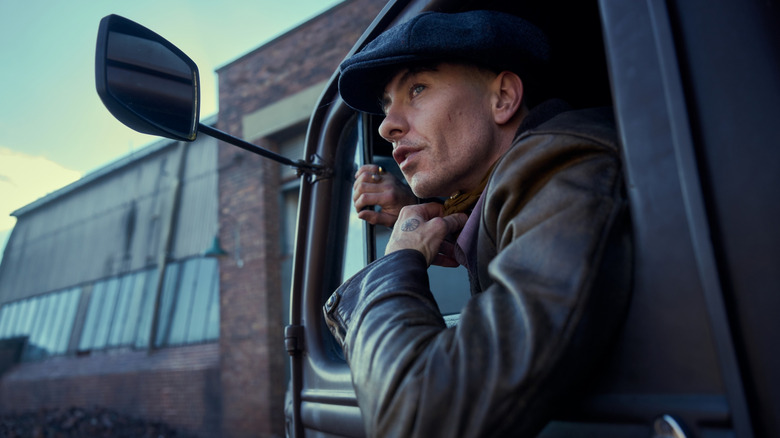 Barry Keoghan as Duke Shelby leaning out of the window of a truck in Peaky Blinders: The Immortal Man