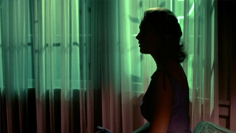 Vertigo, Judy's face covered in shadow as she sits by a green-lit window
