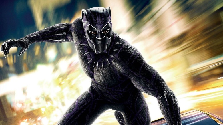 The Black Panther hanging onto a car in Black Panther