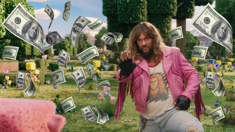 Jason Momoa's Garrison holding his hand up to a sheep surrounded by money in A Minecraft Movie