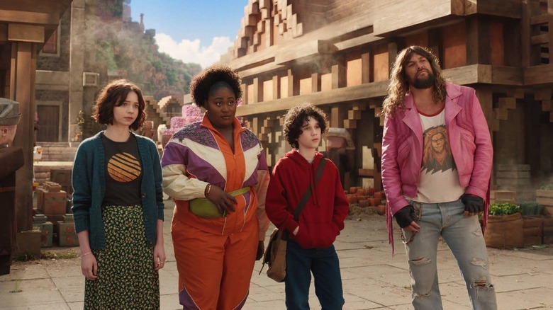 Natalie, Dawn, Henry, and Garrett staring at something in A Minecraft Movie