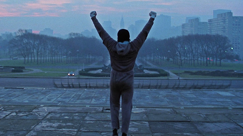 Rocky celebrates after reaching the top of the stairs