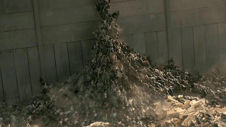 The horde of zombies climbing up the wall in World War Z