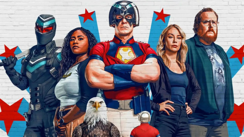 Peacemaker looking up at a mural of Vigilante, Leota Adebayo, himself, Emilia Harcourt, John Economos, and Eagly on the Peacemaker season 2 poster