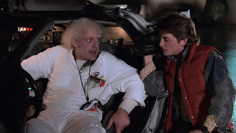 Marty filming Doc explain how the DeLorean time machine works in Back to the Future