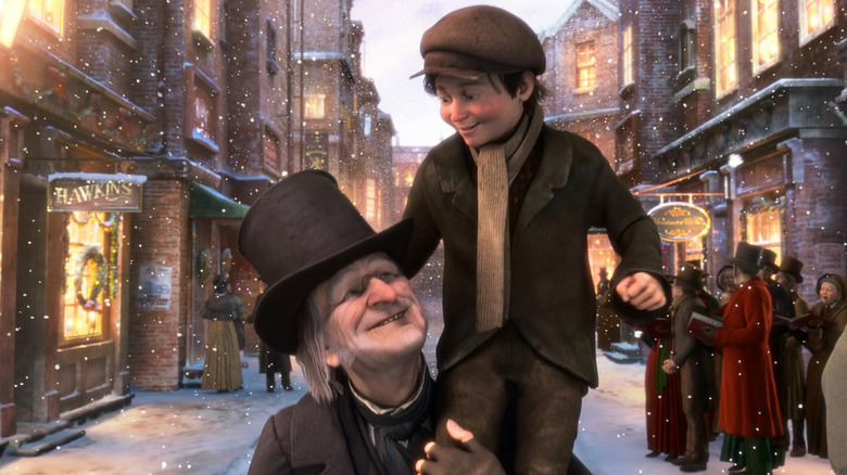 Scrooge holding up Tiny Tim in A Christmas Carol (2009)