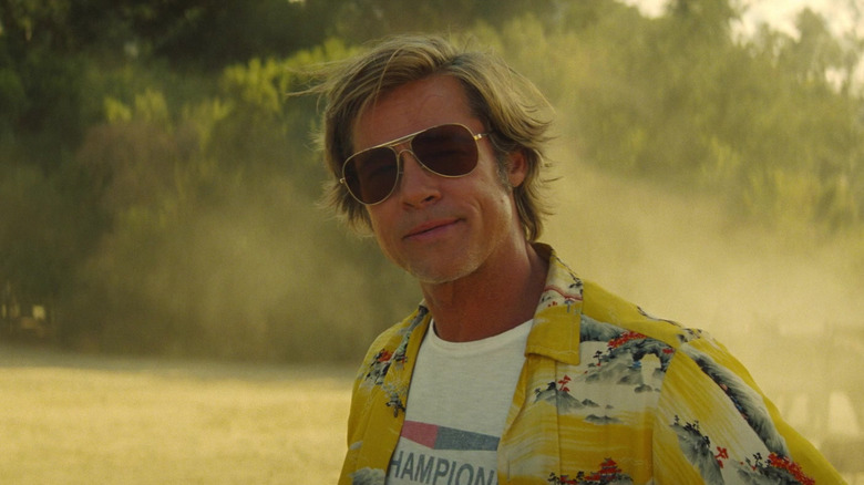 Brad Pitt as Cliff Booth wearing sunglasses in Once Upon a Time in Hollywood