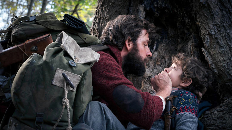 Lee (John Krasinski) covers Marcus's (Noah Jupe) mouth