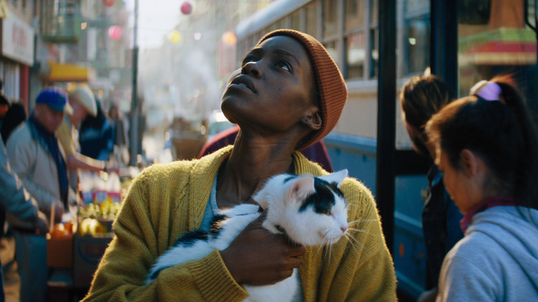 Lupita Nyong'o holding a cat in NYC in A Quiet Place: Day One