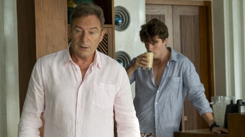 Timothy looking distracted and Saxon drinking a smoothie on The White Lotus