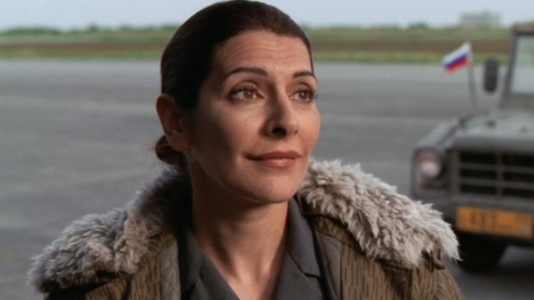 Marina Sirtis' Svetlana Markova looks across frame as she stands on a runway in Stargate SG-1