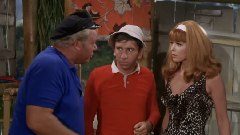 Bob Denver's Gilligan standing between Alan Hale Jr's Jonas Grumby and Tina Louise's Ginger Grant in Gilligan's Island