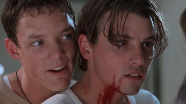 Stu and Billy menacingly looming over Sidney in Scream