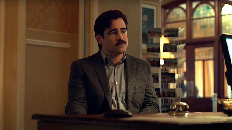 Colin Farrell sits at a desk in The Lobster