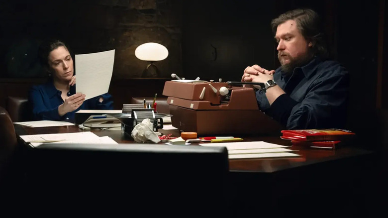 Devon reading a page and Ricken at a typwriter on Severance.