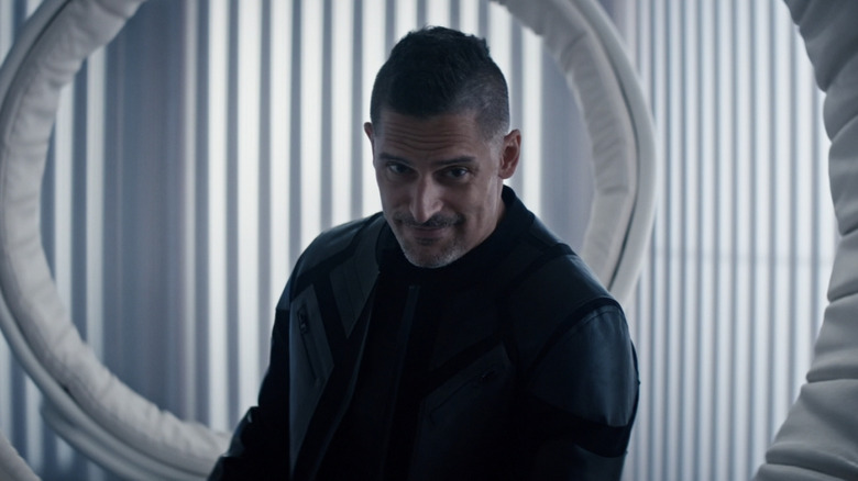 Joe Manganiello as Tomm Schultz sitting in a big hoop chair on Moonhaven