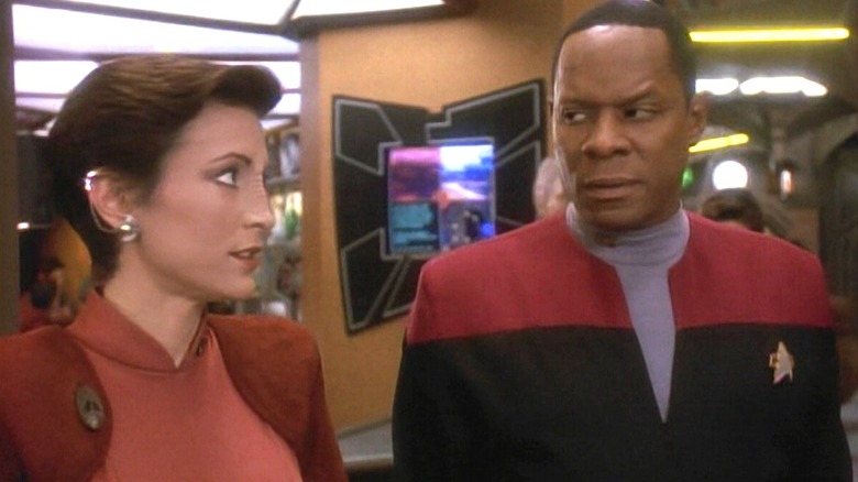 Major Kira looking at Commander Sisko on Star Trek: Deep Space Nine