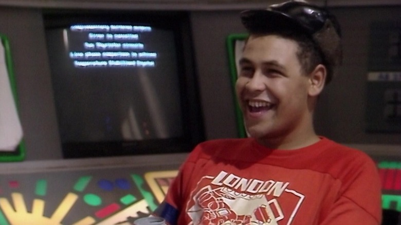 Lister smiling with a beer on Red Dwarf