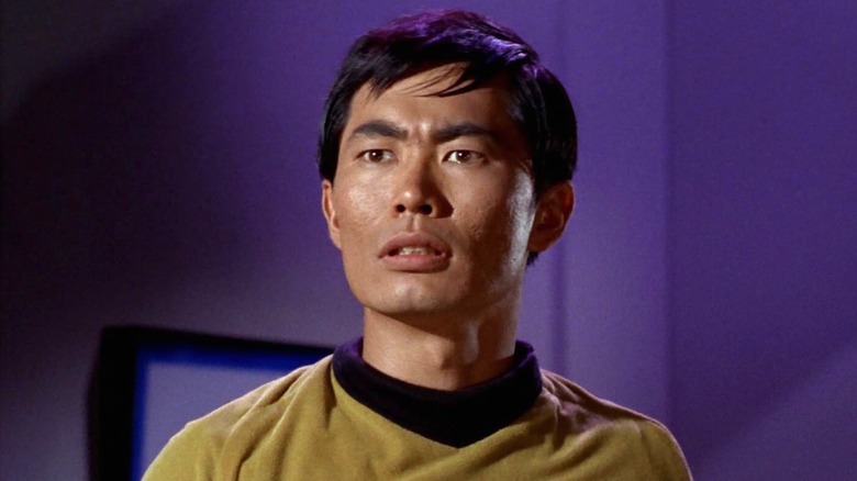 Sulu looking hurt in a conference room on Star Trek