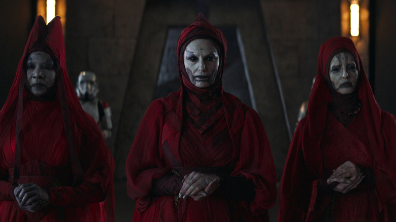 Aktropaw (Jeryl Prescott Gallien), Klothow (Claudia Black), and Lakesis (Jane Edwina Seymour) walking in a temple in Ahsoka season 1