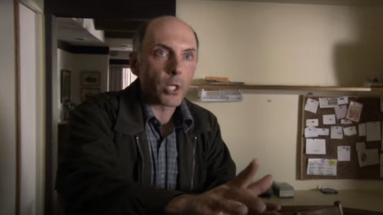 Dan Castelaneta's Joe Spencer holds his hands out as he talks in Stargate SG-1