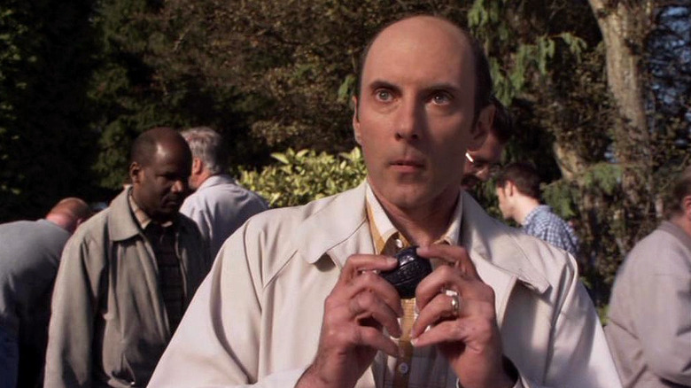Dan Castelaneta's Joe Spencer holds his hands out as he talks in Stargate SG-1