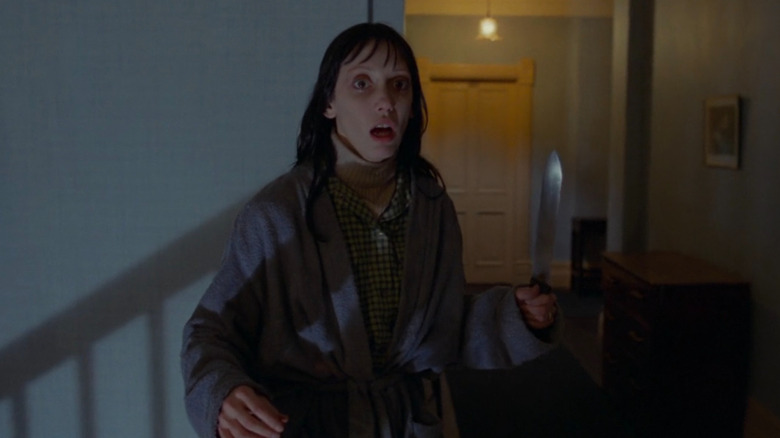 Wendy Torrance holding kitchen knife in Overlook hallway in The Shining