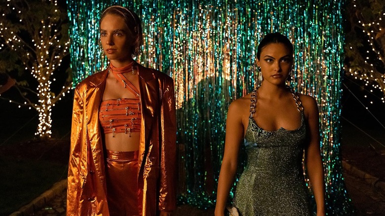 Maya Hawke as Eleanor and Camila Mendes as Drea dressed in snazzy outfits in Do Revenge