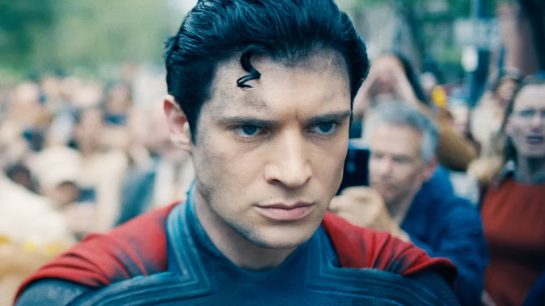 David Corenswet's Superman looks worried as he walks through a crowd in Superman