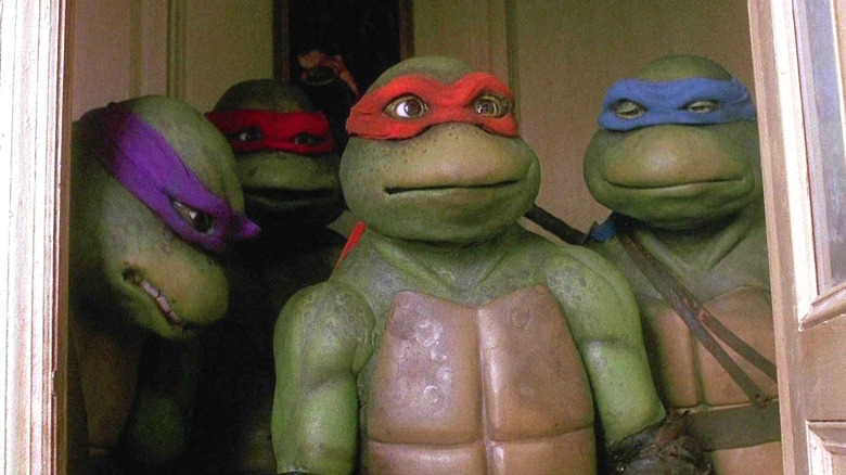 Donatello, Raphael, Michelangelo, and Leonardo looking distraught in Teenage Mutant Ninja Turtles (1990)