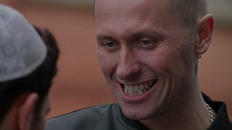 A Nazi punk grinning evilly in The Infiltrator