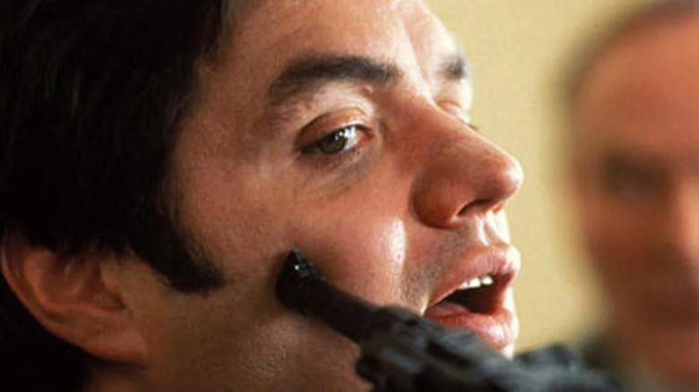 Yaron Svoray with a gun pressed against his cheek in The Infiltrator