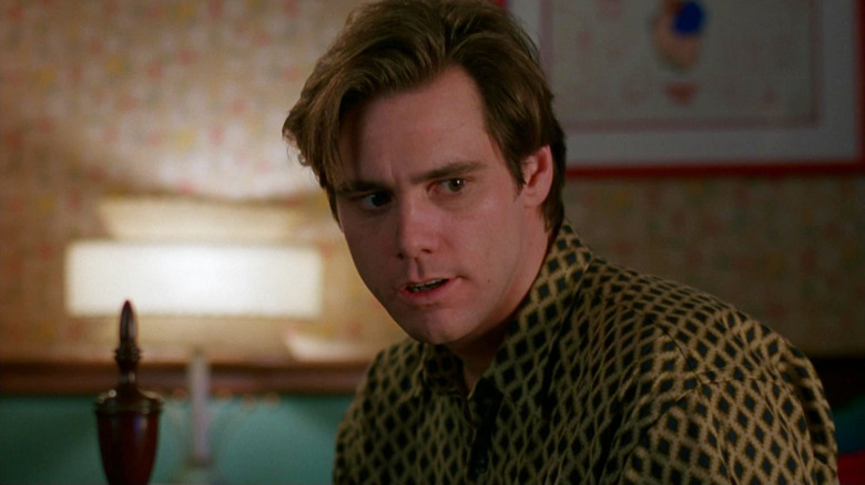 Jim Carrey as Stanley Ipkiss looking intrigued in The Mask